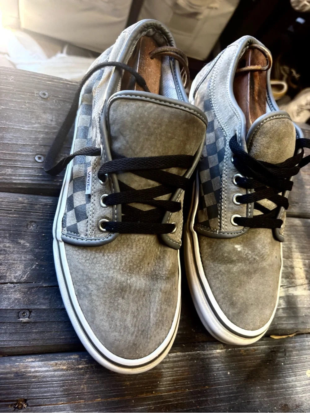 Vans gray suede sneakers with black & white checkerboard pattern on the side